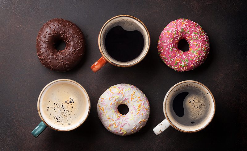 Coffee and donuts on a dark table