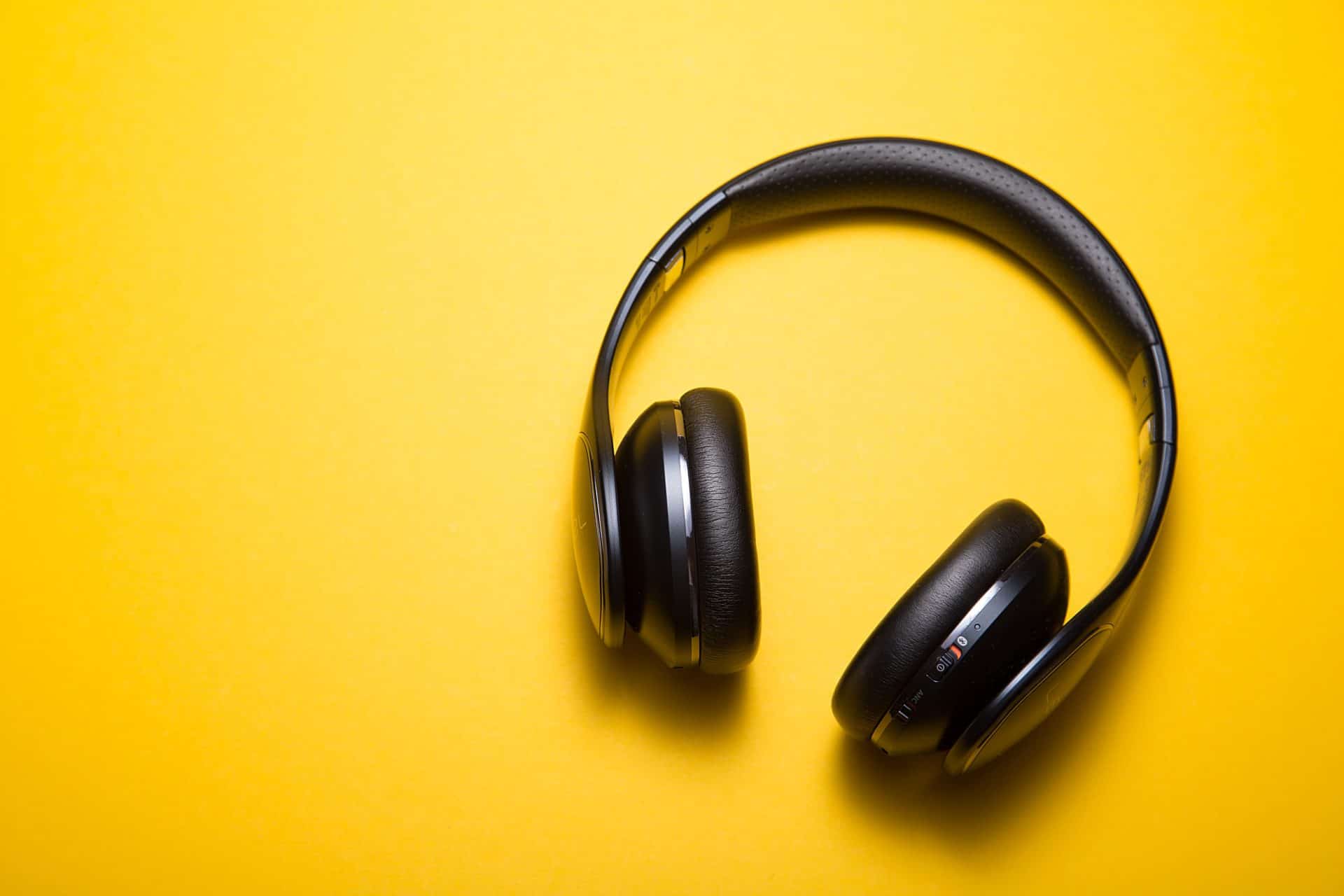 bluetooth headphones on yellow background