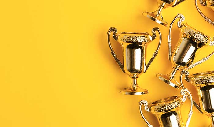 Awards on a yellow background